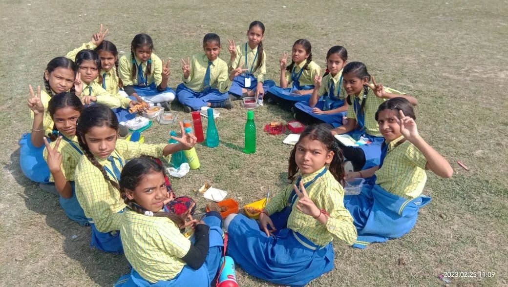 Lunch break, shared on the grass at Ayush Public School